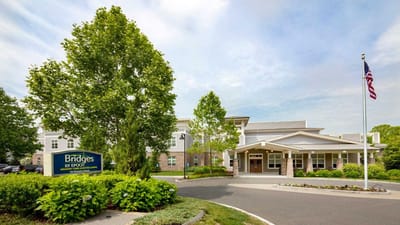 Exterior view of a senior living facility with signage