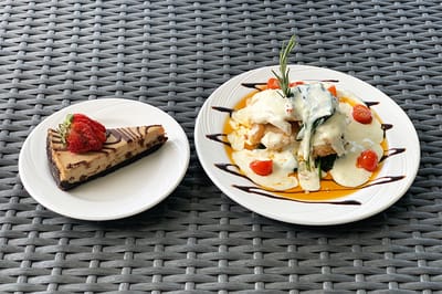 A plate of food with a dessert on the side