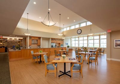 Dining area with tables and chairs in a bright interior