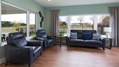 Bright common area with seating and large windows