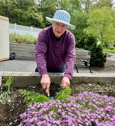 Resident gardening in a vibrant outdoor space