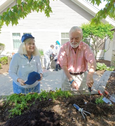 Residents gardening together in a facility garden