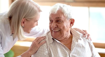 Caregiver interacting warmly with a resident