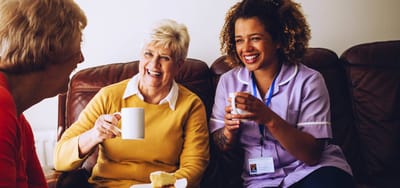 Residents enjoying tea and conversation with staff