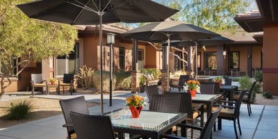 Outdoor patio area with tables and chairs