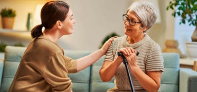 Caregiver interacting with a resident in a cozy setting