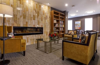 Cozy common area with seating and bookshelves