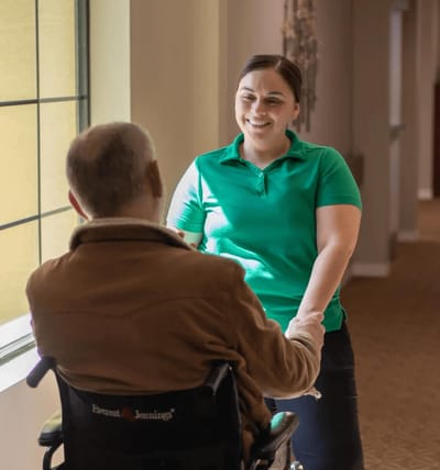 Staff member engaging with a resident in a corridor