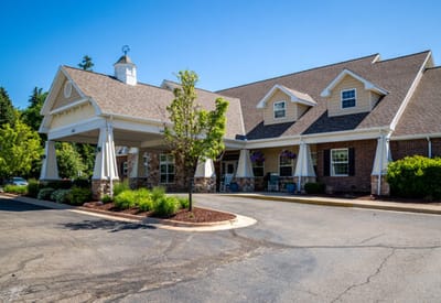 Exterior view of a senior living facility with gardens