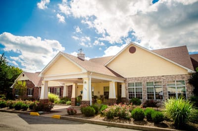 Exterior view of a senior living facility with landscaped entrance