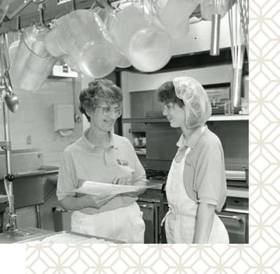 Staff members engaged in kitchen activities
