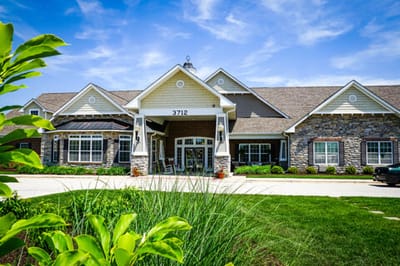 Exterior view of a senior living facility with landscaped gardens