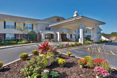 Exterior view of the facility with flower beds