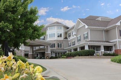 Exterior view of a senior living facility with garden