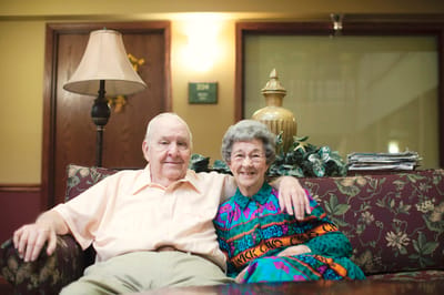 Senior couple sitting together on a couch