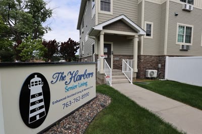Entrance and logo of The Harbors Senior Living facility