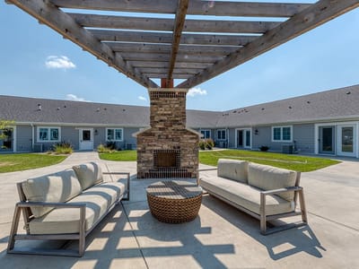 Outdoor seating area with a fireplace and couches