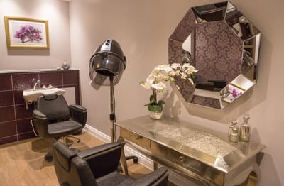 Hair salon area with styling chairs and equipment