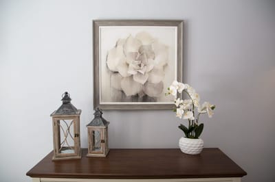 Decorative floral painting and lanterns on a dresser