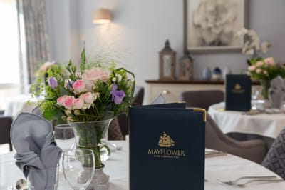 Elegant dining setup with flowers and menus