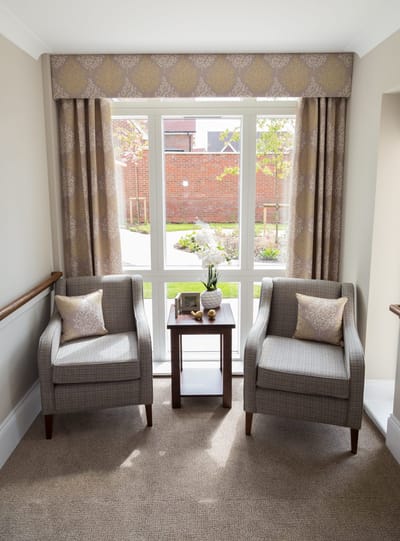 Bright seating area with two chairs and a side table