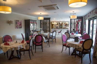 Elegant dining room setup with tables and chairs
