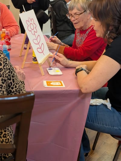Residents and staff participating in an arts and crafts activity