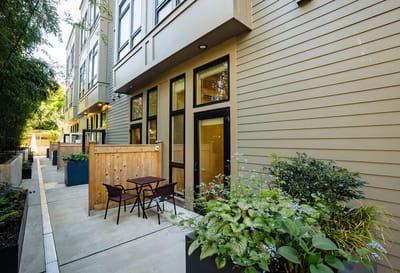 A serene outdoor patio area with plants and seating