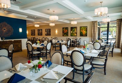 Elegant dining room setup with tables and flowers