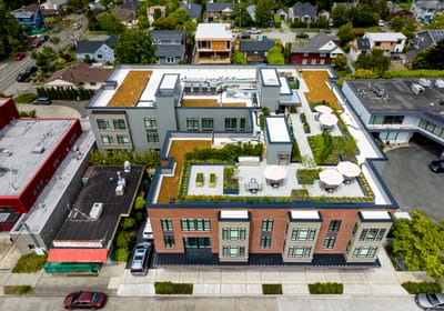 Aerial view of a modern senior living facility with green roof areas