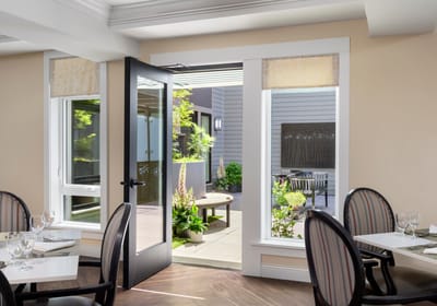 View from an interior dining area to an outdoor space