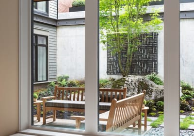 Outdoor courtyard with benches and greenery
