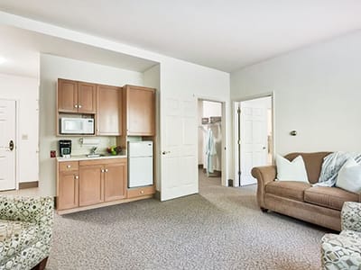 Cozy resident room with kitchenette and living area