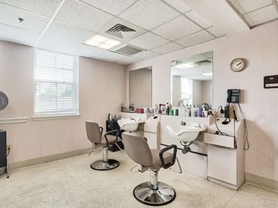 Hair salon area with styling chairs and mirrors