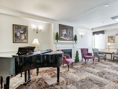 Common area with a piano and seating