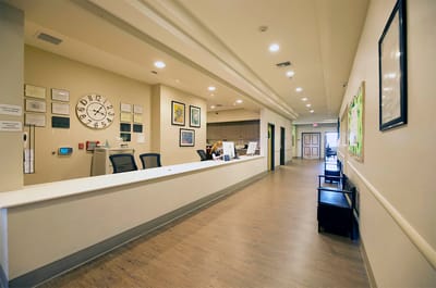 Bright reception area with a desk and seating
