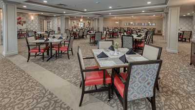 Dining area with tables and chairs set for meals