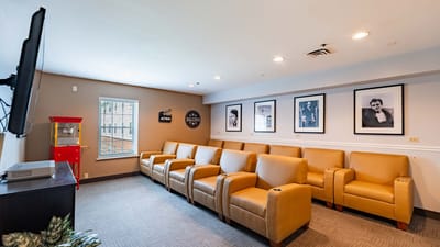 A cozy common area with seating and framed photos