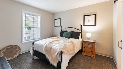 A cozy resident bedroom with natural light