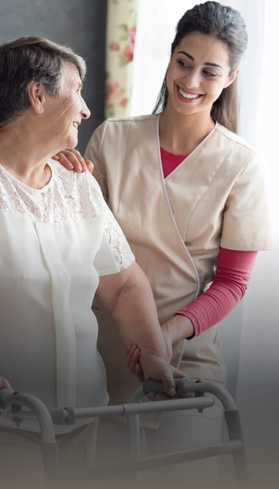 Care staff assisting a resident in a bright room
