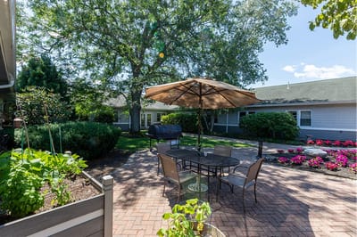 Outdoor patio area with seating and landscaping