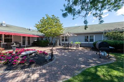 Outdoor patio area with seating and flowers