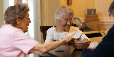 Residents engaged in a social activity at a table