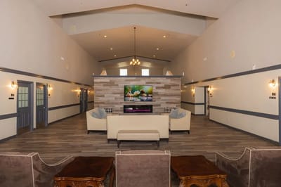 Spacious common area with seating and TV