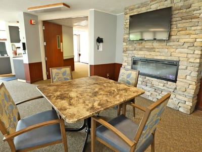 Cozy common area with a table and fireplace