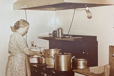 A staff member cooking in a facility kitchen