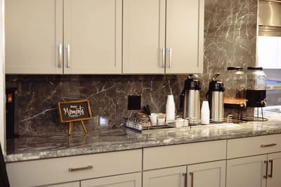 Coffee station with cups and snacks in a kitchen