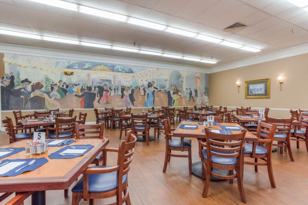Dining room with tables and a mural