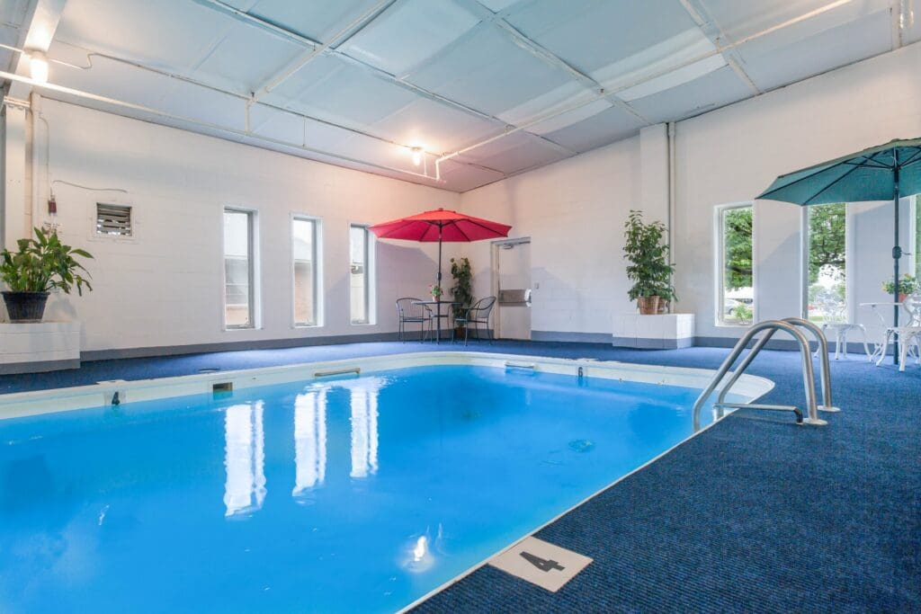 Indoor pool area with colorful umbrellas
