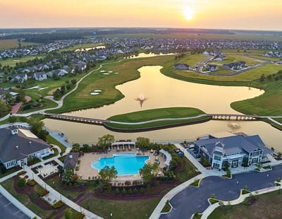 Aerial view of a swimming pool and lake at the facility